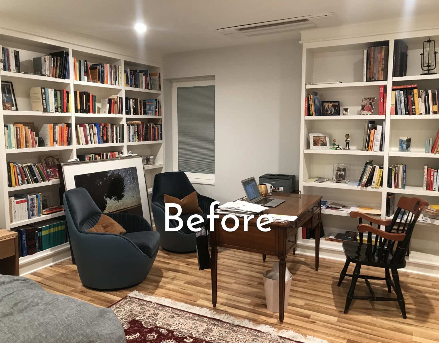 A basement bedroom with a bed, two chairs and a book shelf