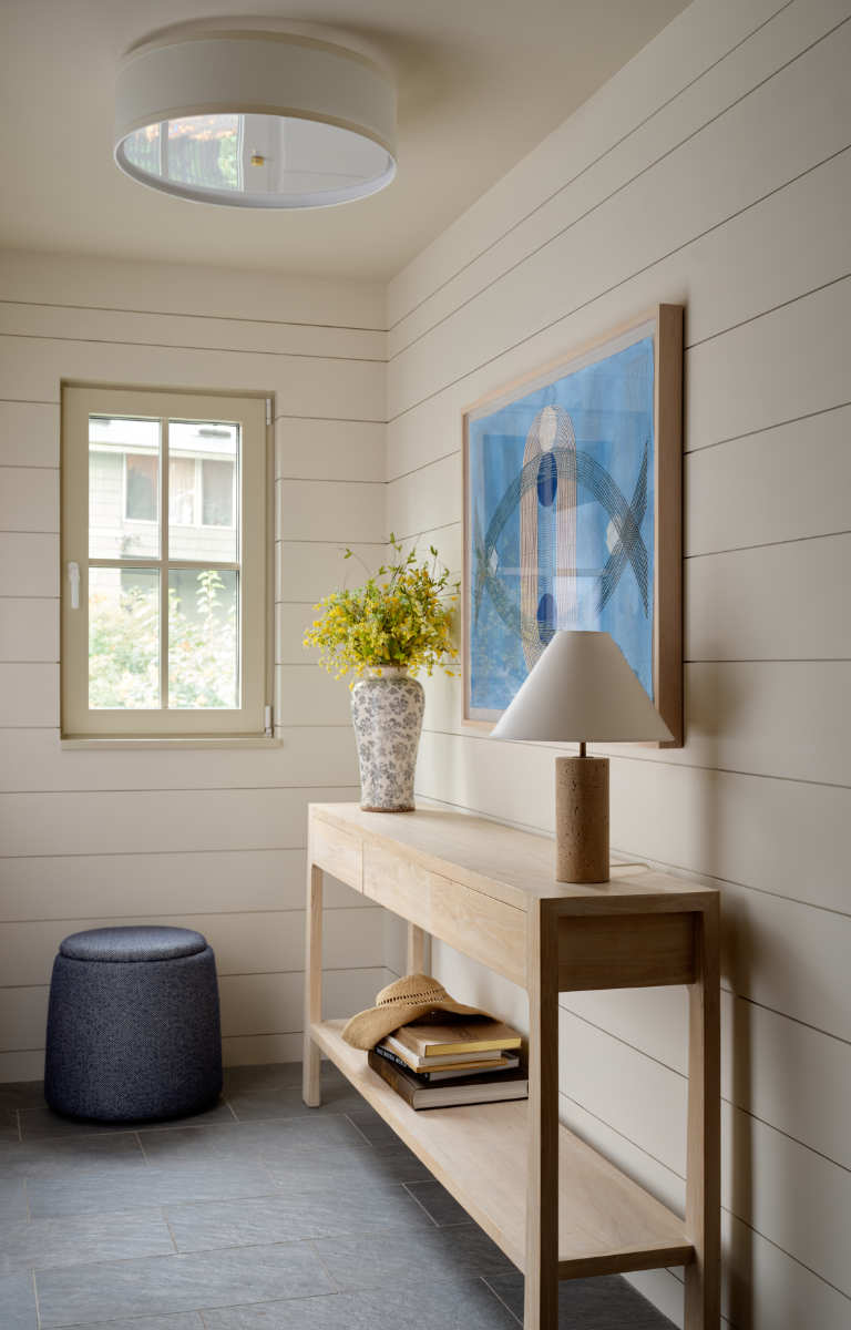 A wooden table with a lamp on top of it